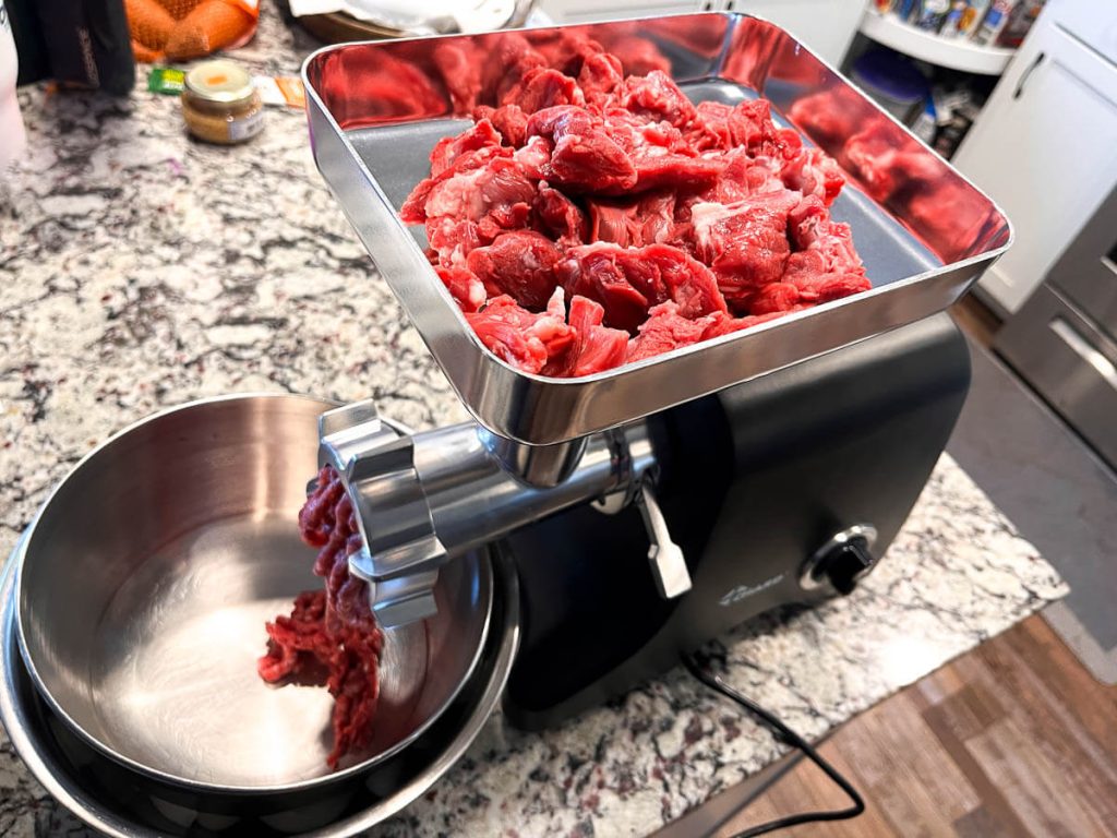 Badger meat going into a Chard meat grinder