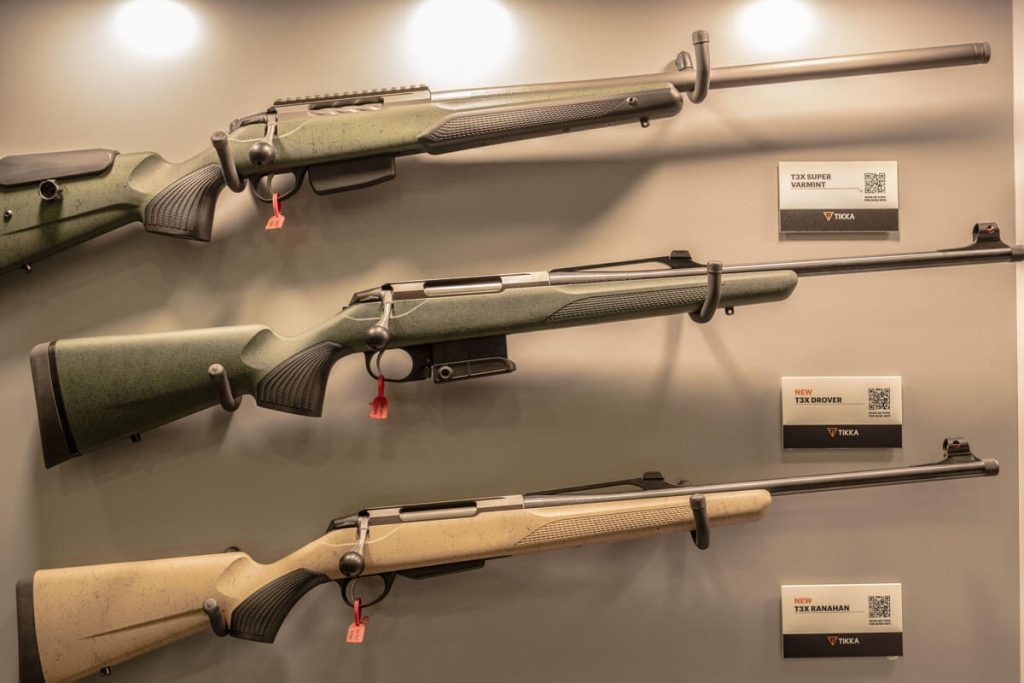 Three Tikka rifles hanging up at NRAAM 2024. 