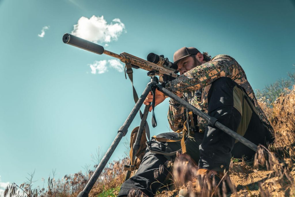 A shooter using the TFCX-13 tripod to support his rifle