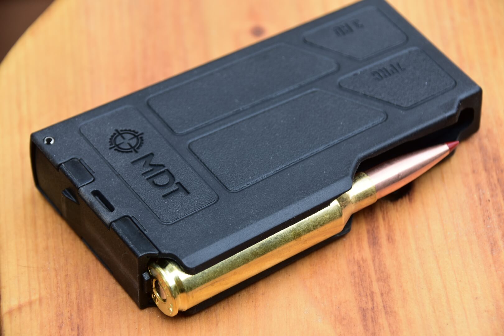 Closeup view of the Model 307 magazine with a bullet loaded in it.