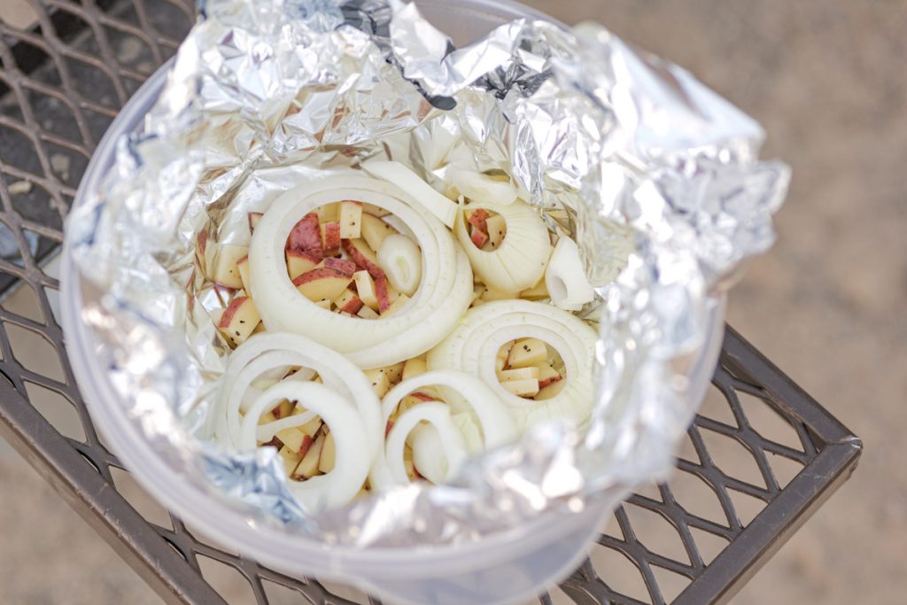 Vegetables all set up in tin foil ready to be made into hobo dinner