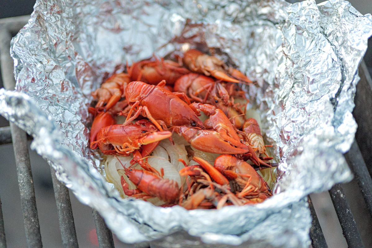 Hobo dinner made with crawdads and onions in tinfoil