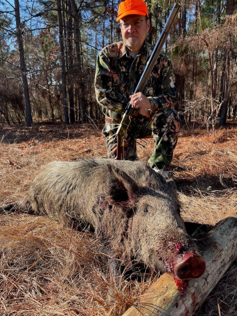 The New Original Henry rifle with the hunter and wild boar it shot