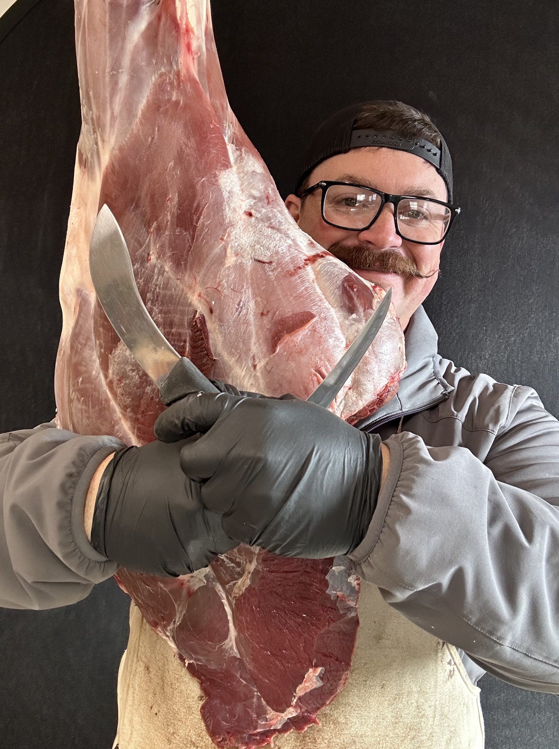 Hunter with large cut of meat ready to prepare