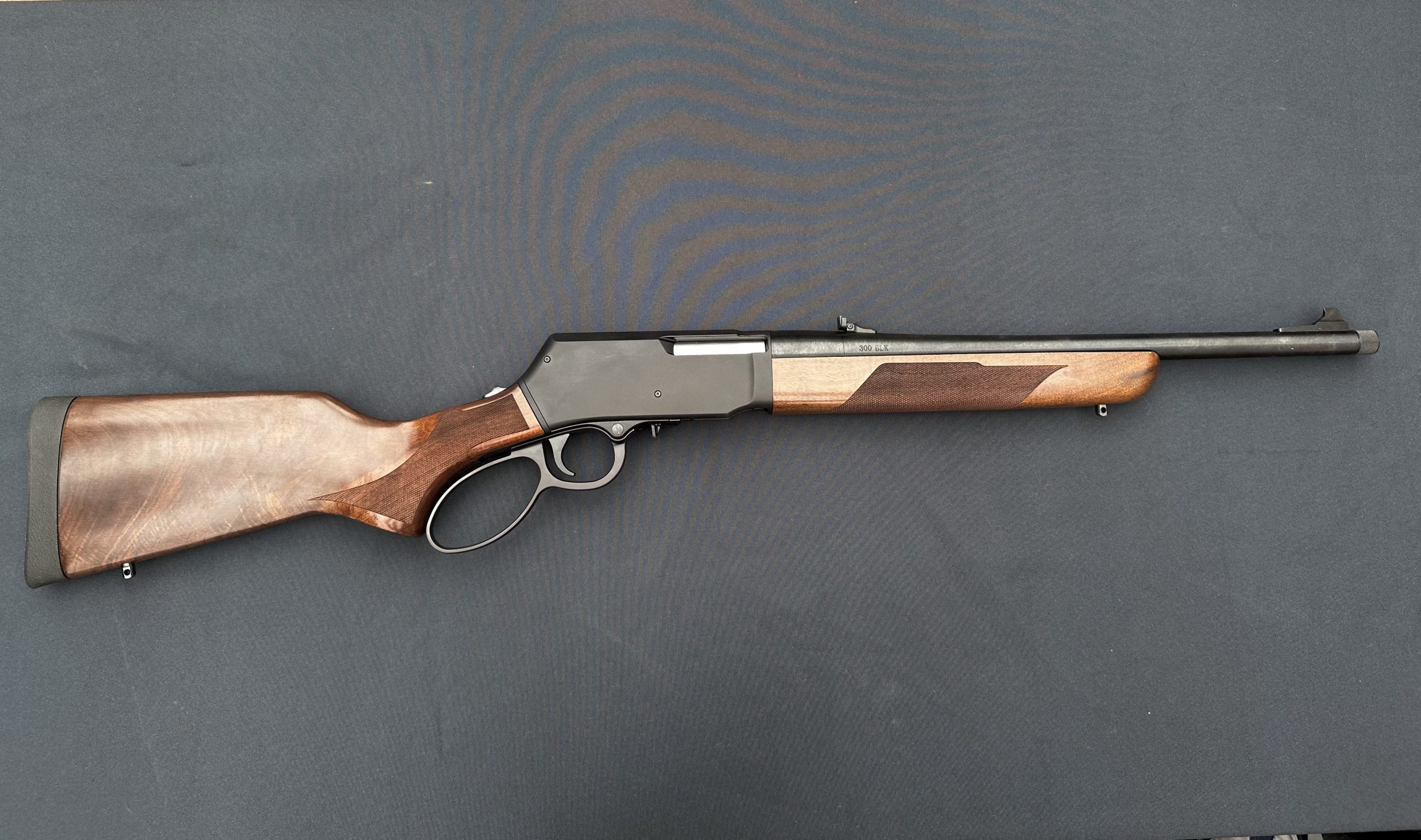 a lever action rifle on the table.