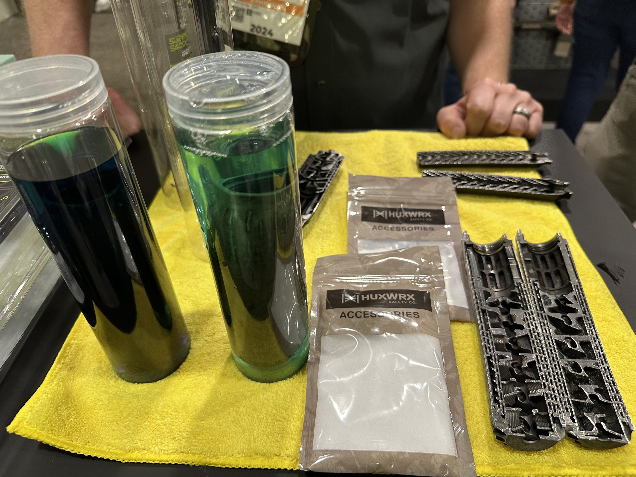 a table is covered in suppressor cleaning solution bottles and powder packets.