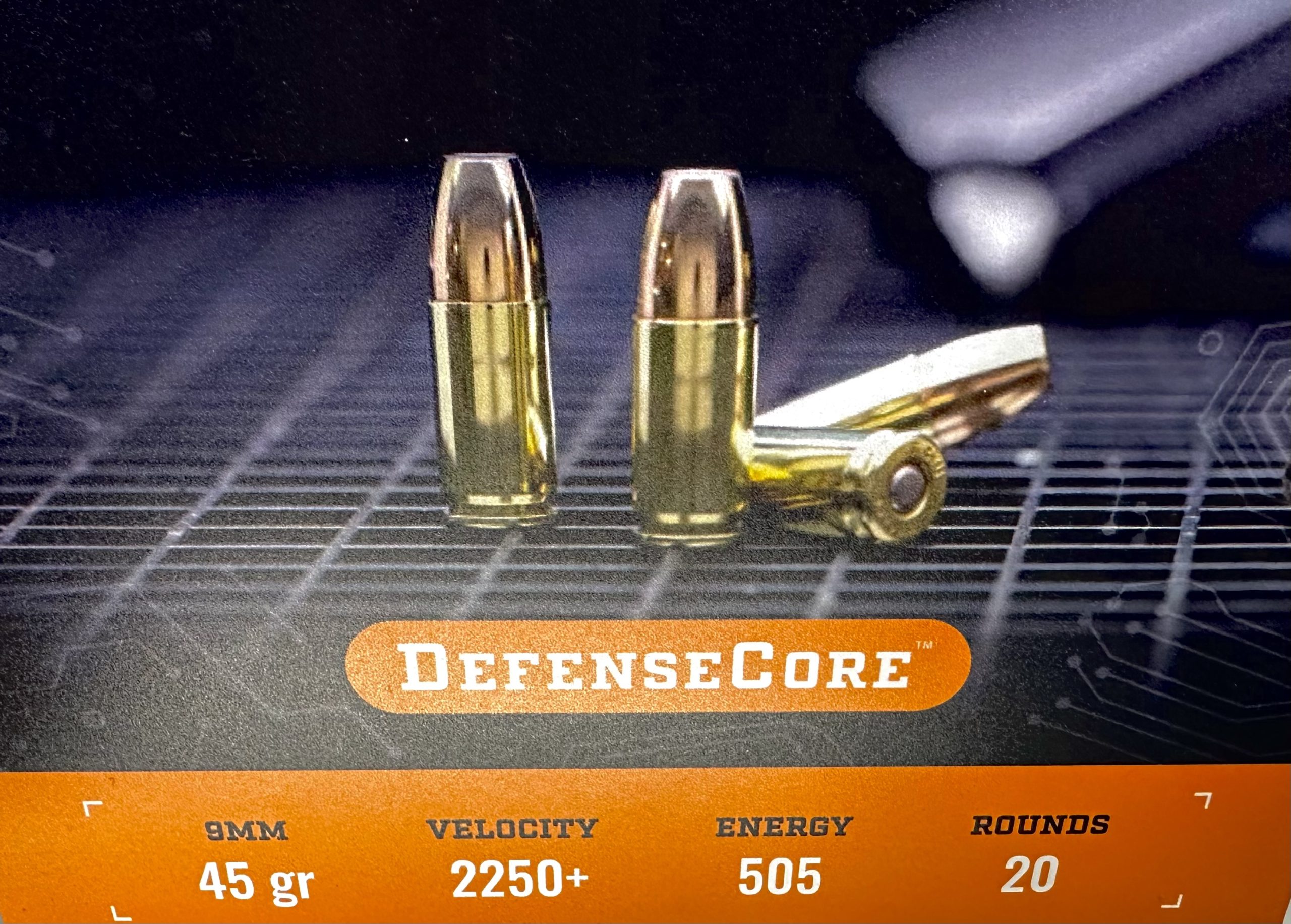 A marketing graphic of DefenseCore ammunition shows velocity, weight, and other information.