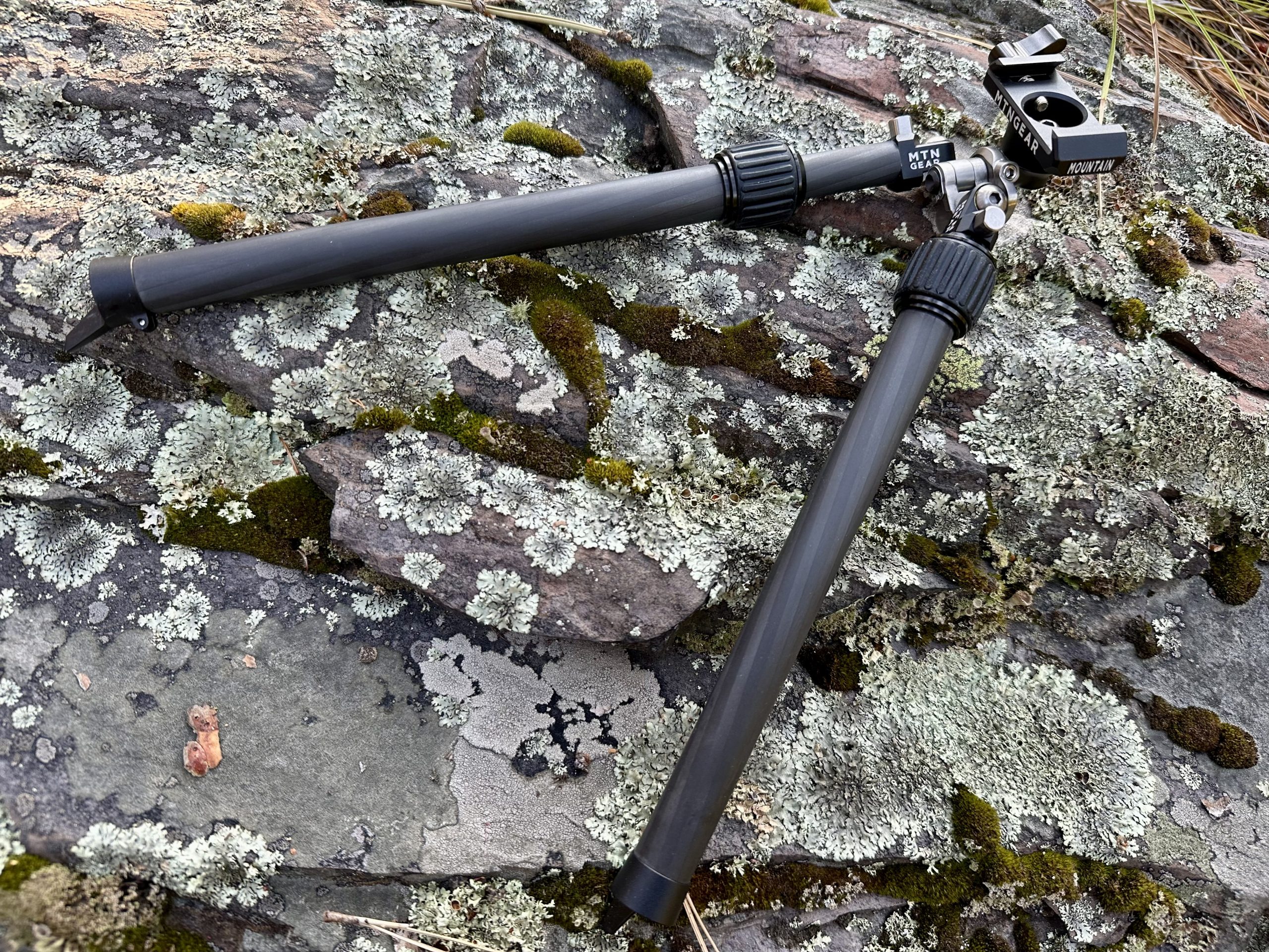 MTNGear Mountain Bipod lays on a rock background.