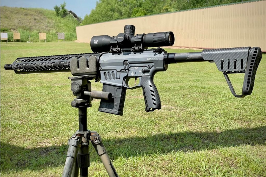 Crown Precision Elite fitted with factory carbon fiber furniture, topped with the Black Collar Arms Forged Carbon Fiber scope mount, and sitting in a carbon fiber Kopfjager K800 tripod