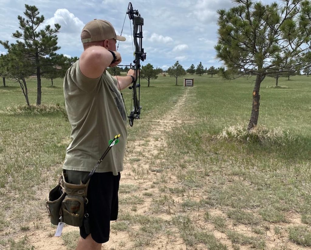 Hunter with bow trained on target