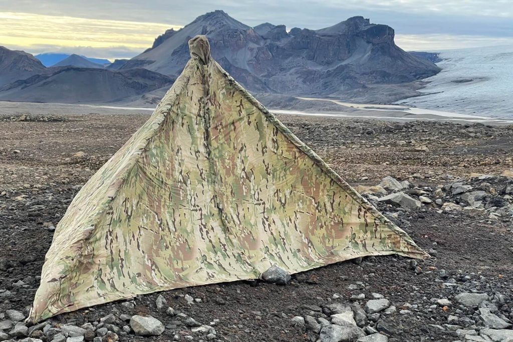 Two Vets Tripods Tripod Tipi tent setup overlooking mountains and a glacier in Iceland