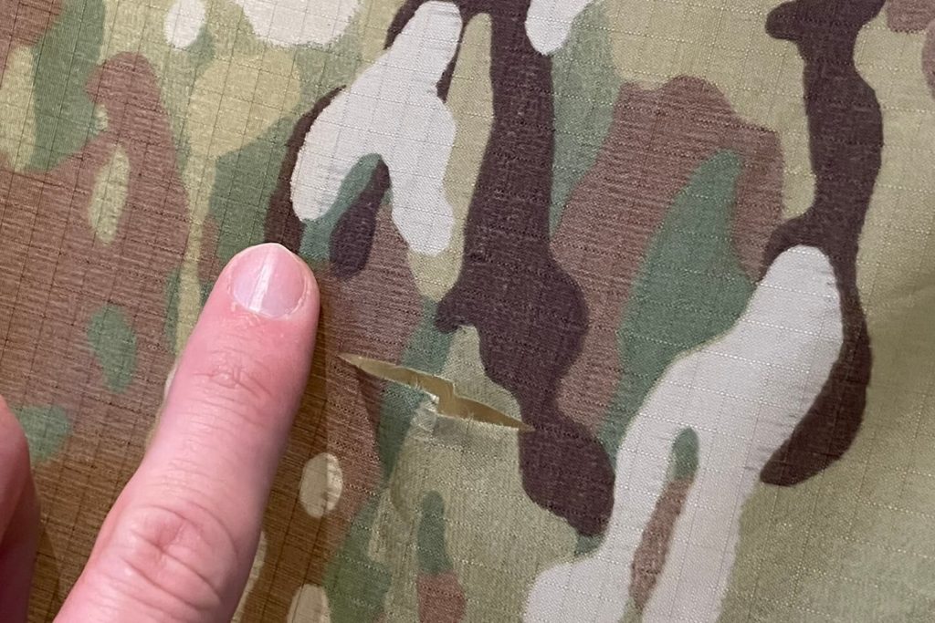 tear in the camo fabric of the tent