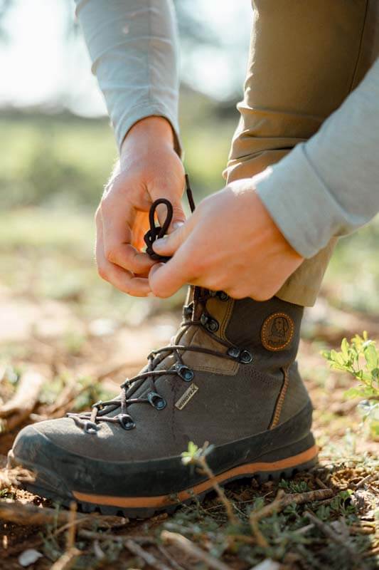 Hunter tying laces on Dedito Luca boots