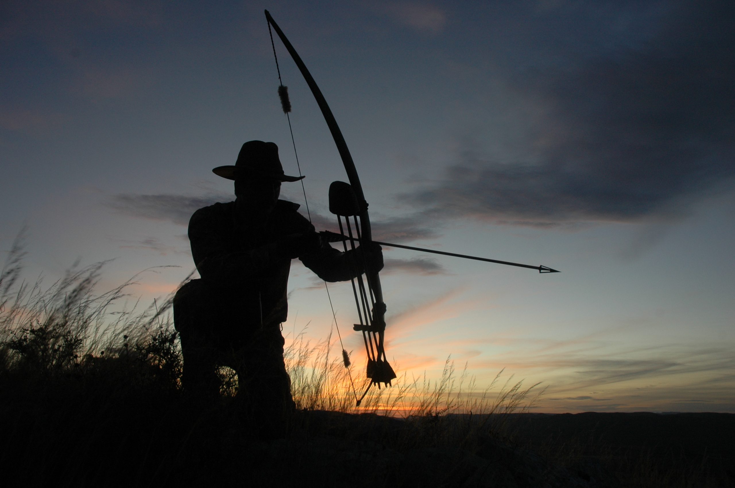 Longbow Elk Hunter silhouetted against sunset