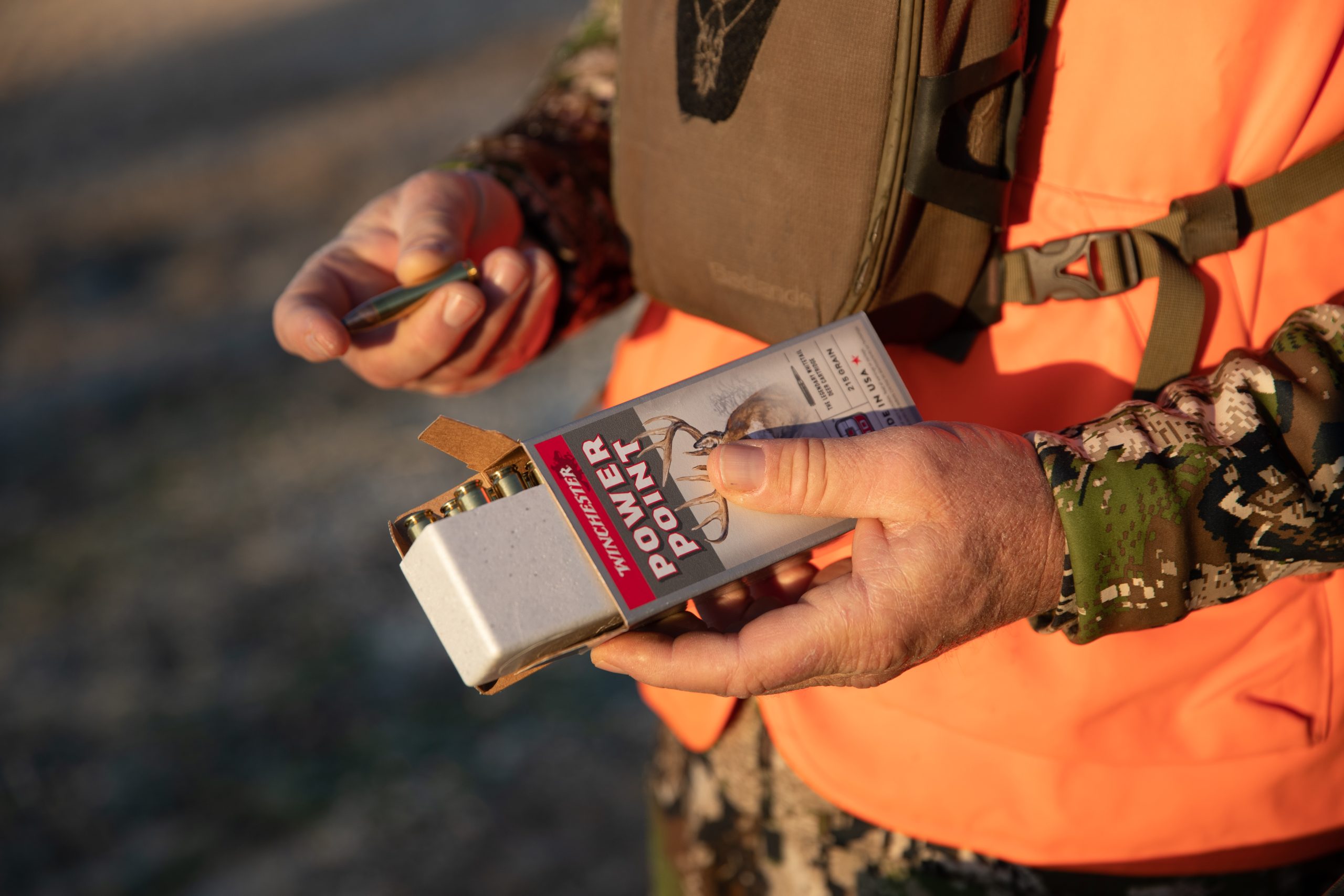 Hunter examining 400 Legend Cartridge