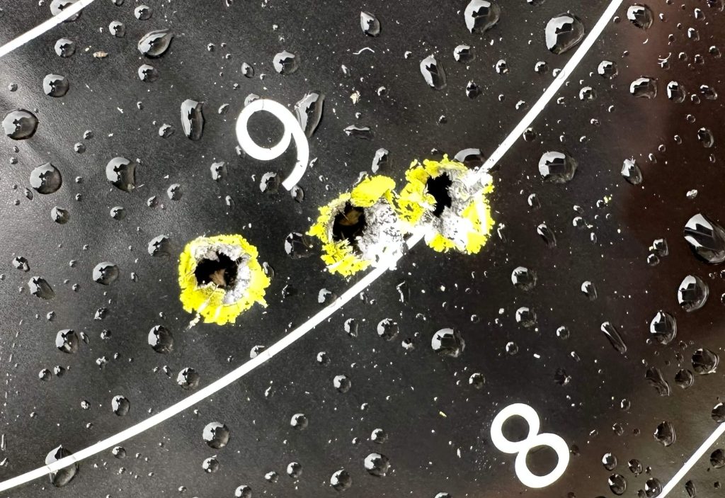 A target with bullet holes and water droplets