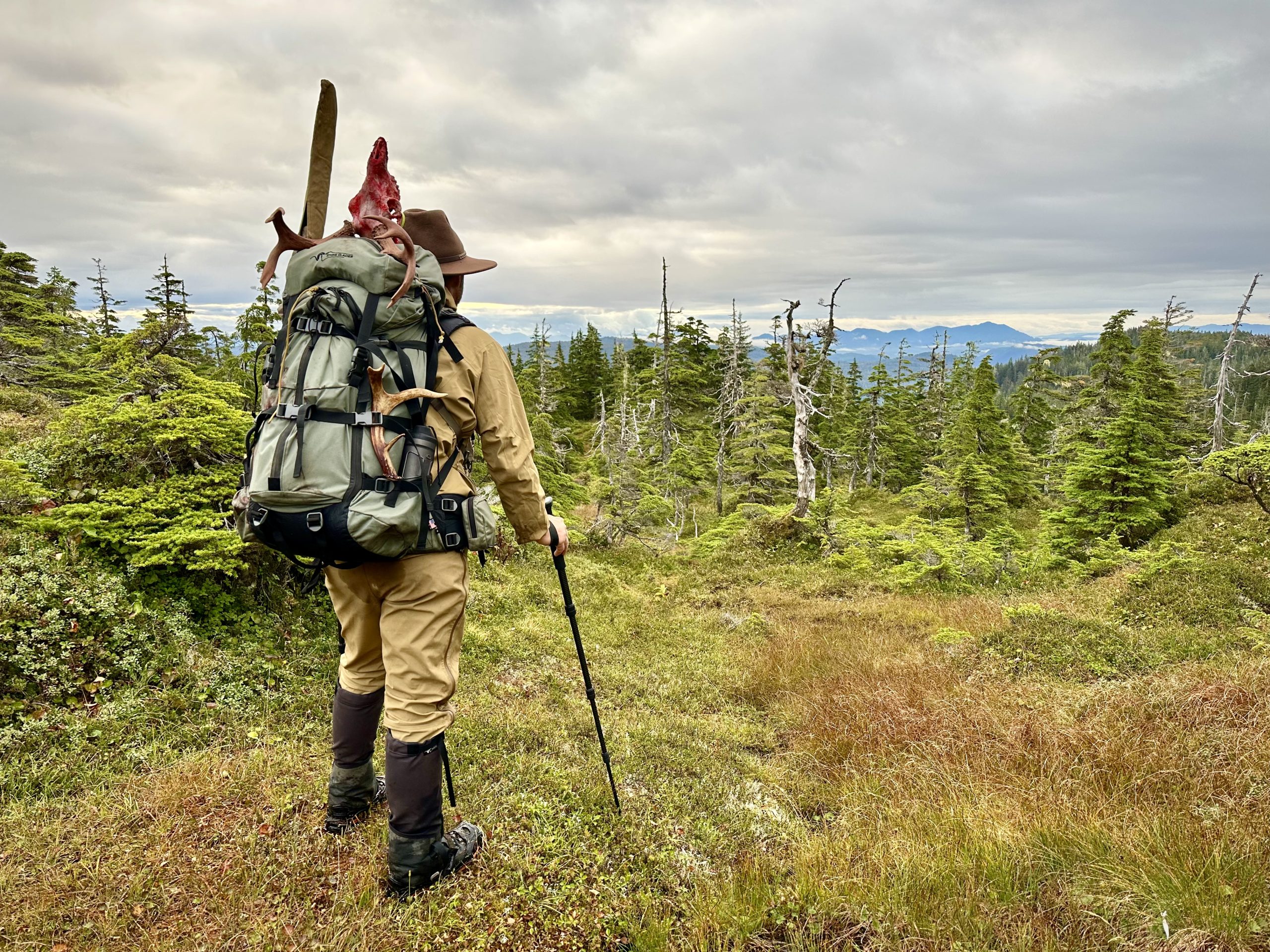 Hunter packing out of Alaskan backcountry with his Sitka blacktail buck