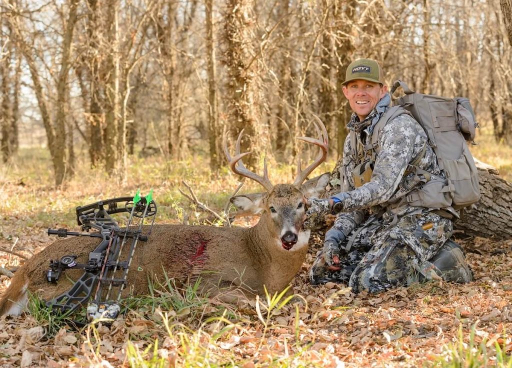 man and buck bowhunting rut