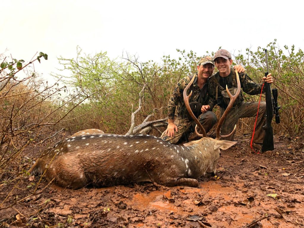 The author and his son with the rainy day buck.