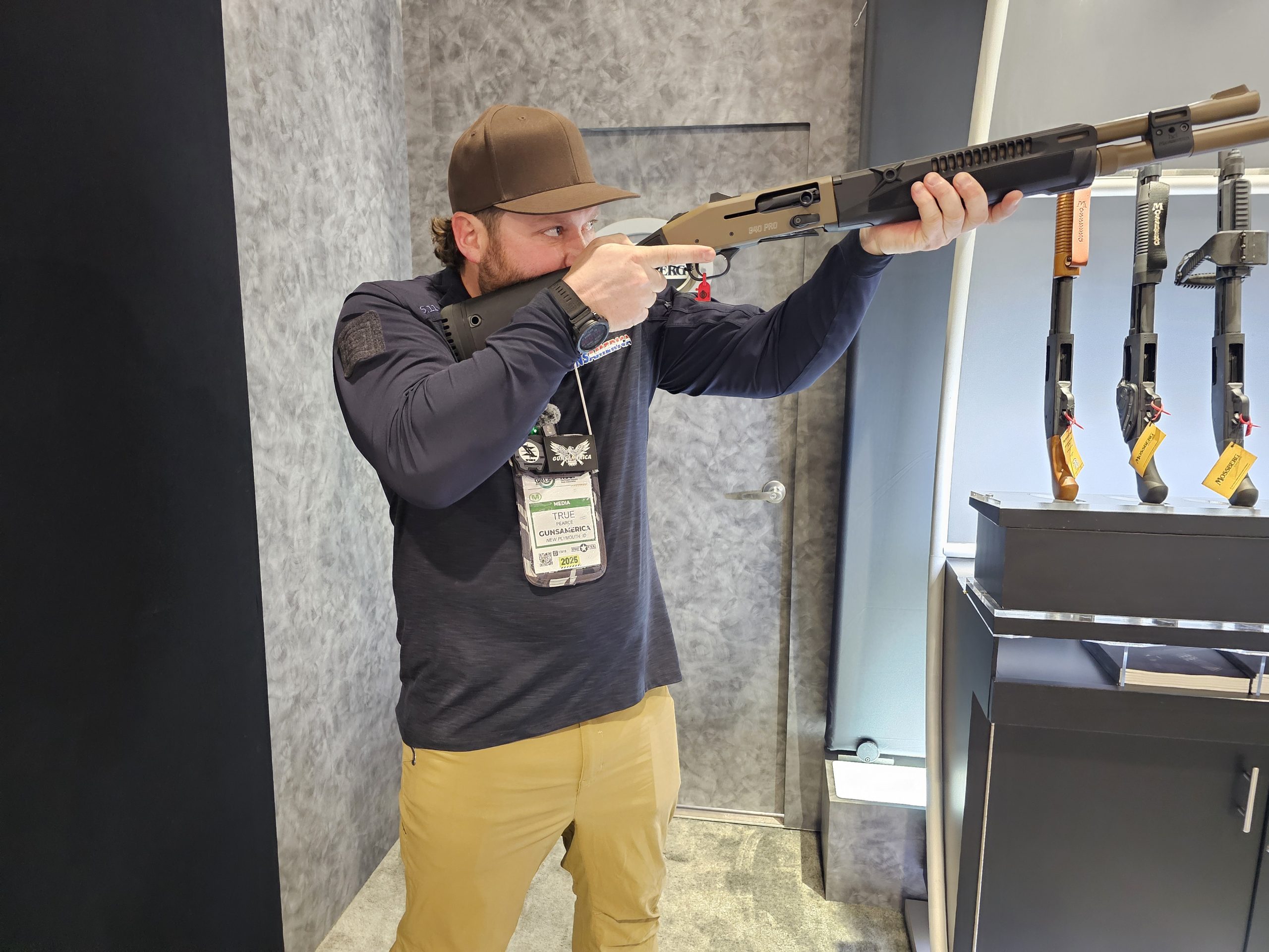 A man holds the Mossberg 940 Pro Tactical SPX like he is shooting it. 