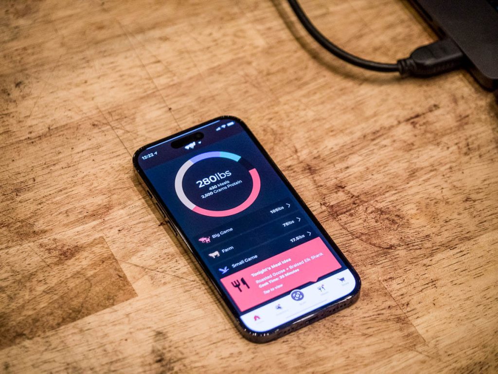 A phone lying on a butcher block showing the meatsafe app.